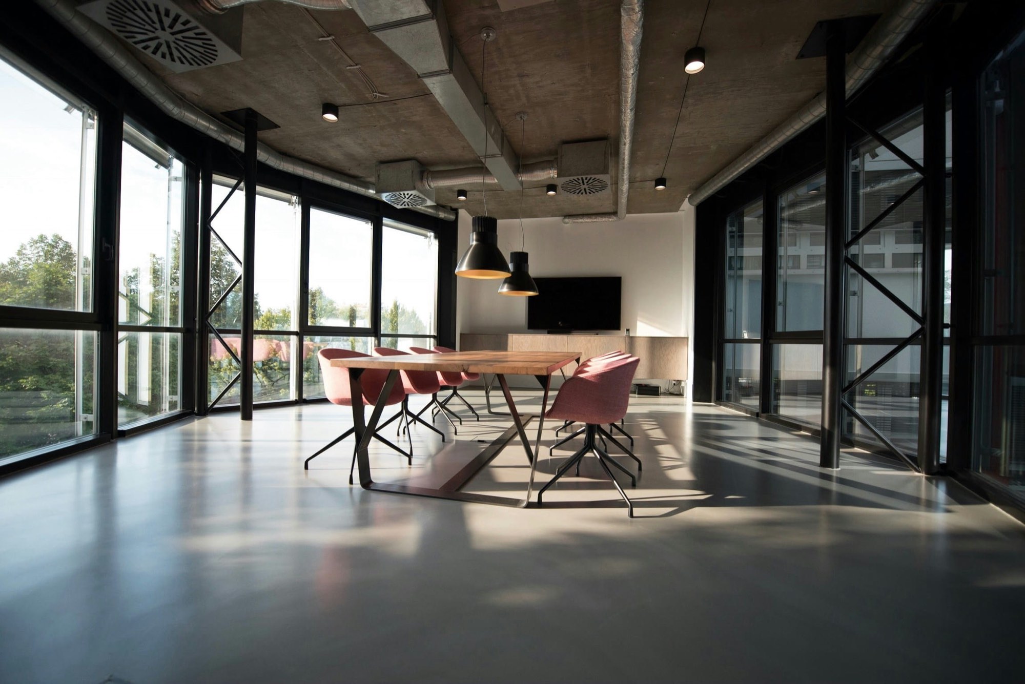 Sunlit office meeting room with a clean floor and conference table